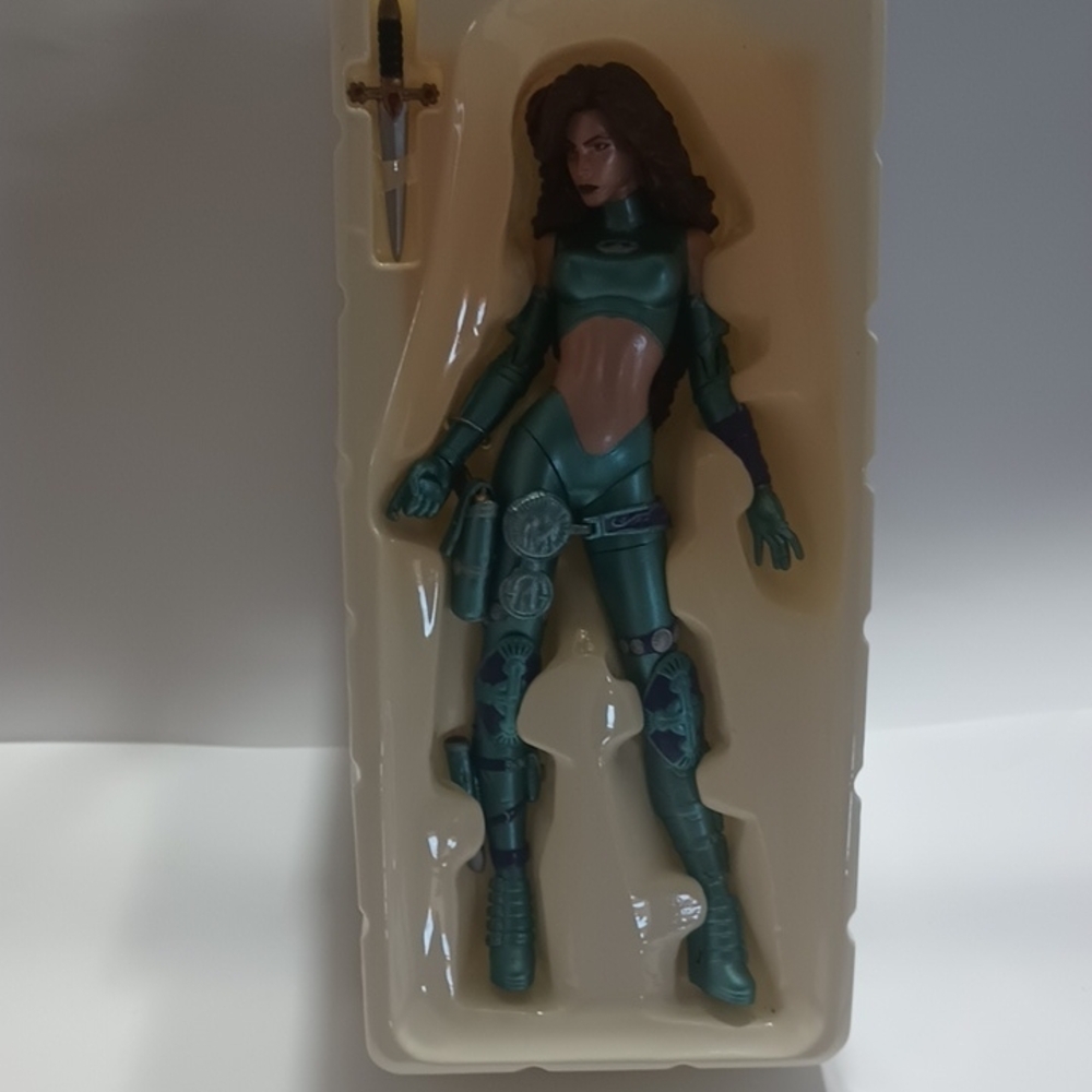 Green Action Figure with Articulated Joints and Stylized Design